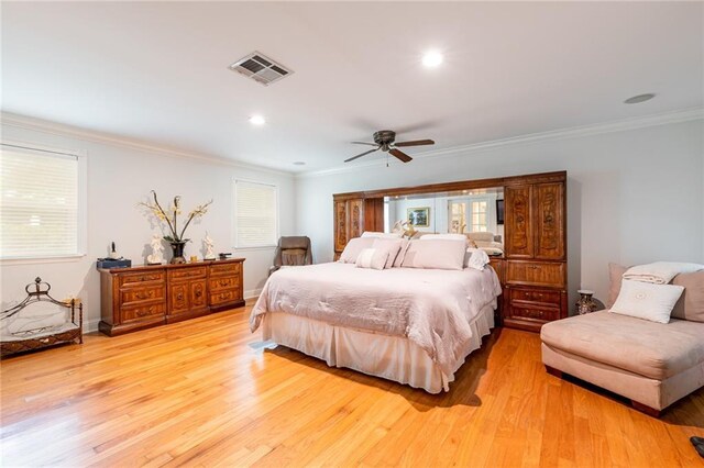 bedroom with ornamental molding, ceiling fan, and light wood-type flooring