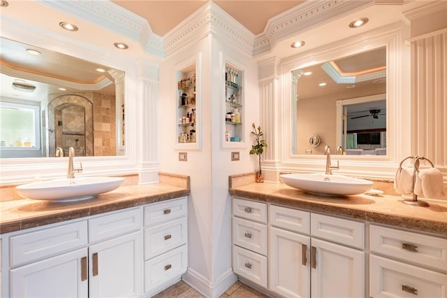 bathroom with vanity, tiled shower, and crown molding