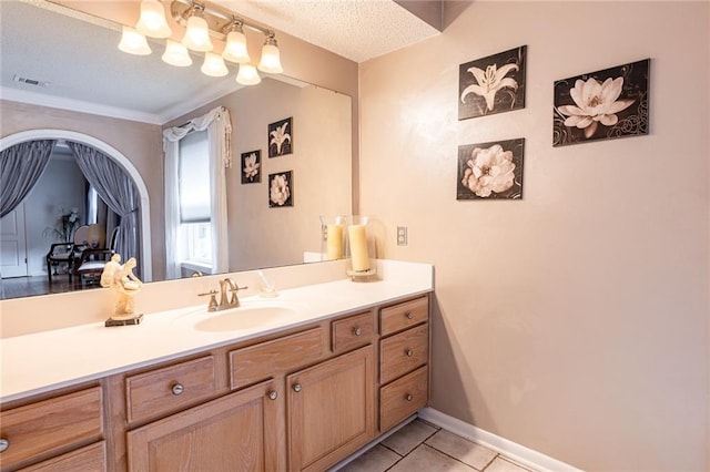 bathroom with vanity, tile patterned flooring, and a textured ceiling