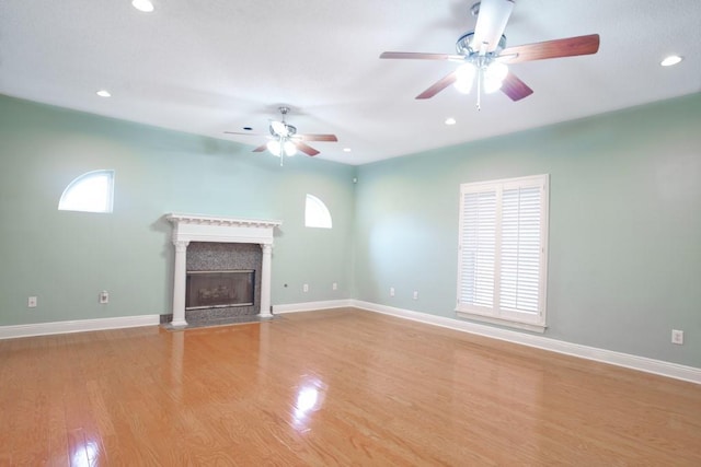 unfurnished living room featuring ceiling fan and light wood-type flooring