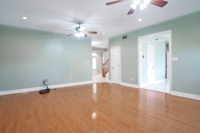 spare room featuring ceiling fan and light wood-type flooring