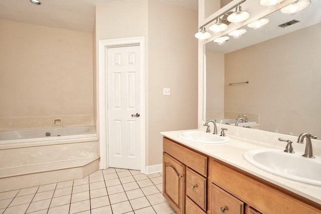 bathroom with vanity, a bath, and tile patterned floors