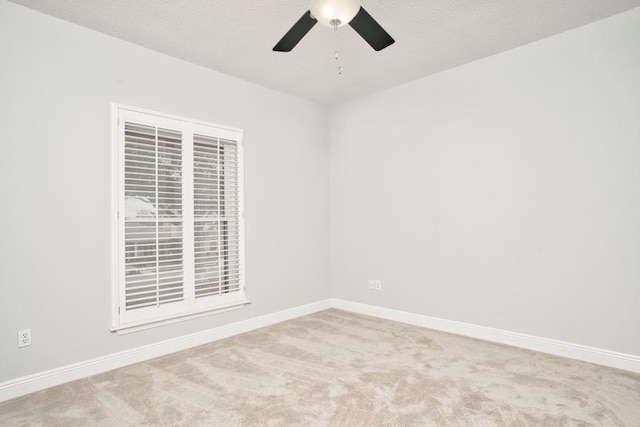 empty room with ceiling fan and light colored carpet