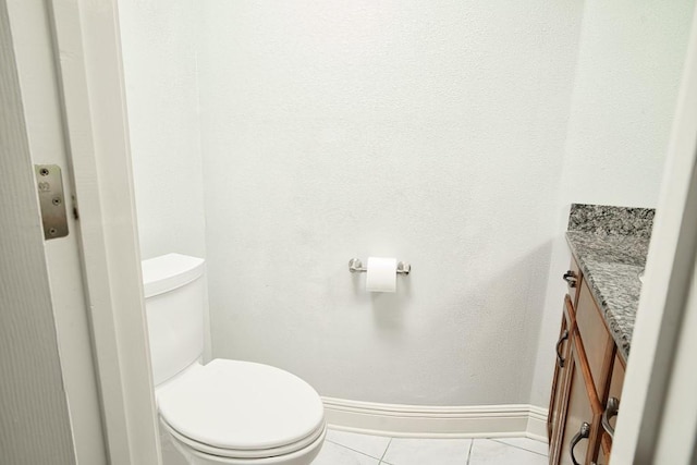 bathroom featuring vanity, tile patterned flooring, and toilet