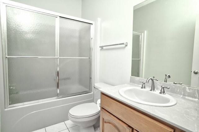 full bathroom with vanity, tile patterned floors, shower / bath combination with glass door, and toilet