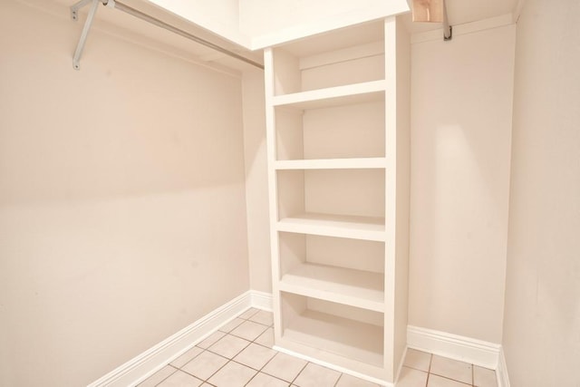 walk in closet with tile patterned floors