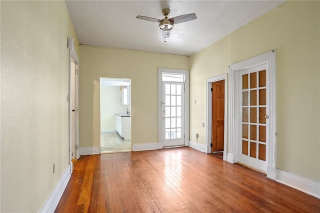 unfurnished room with ceiling fan and light wood-type flooring