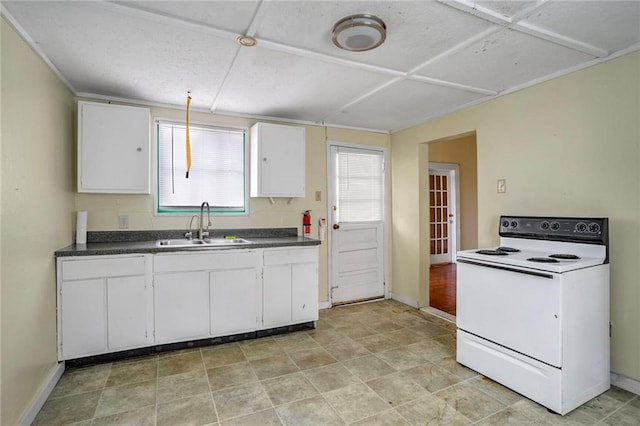 kitchen with electric range, white cabinetry, and sink