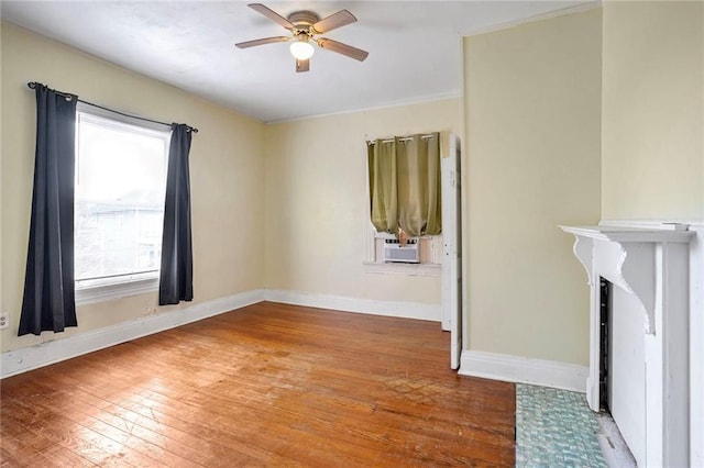 unfurnished room featuring hardwood / wood-style flooring, ceiling fan, and cooling unit