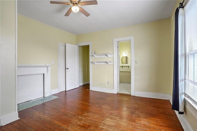 unfurnished bedroom featuring ceiling fan, dark hardwood / wood-style floors, and connected bathroom