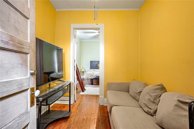 living room featuring hardwood / wood-style flooring and ornamental molding