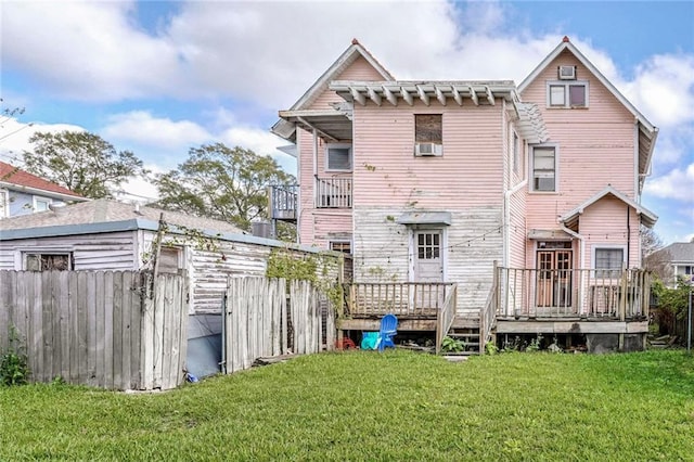 back of house featuring a deck and a yard