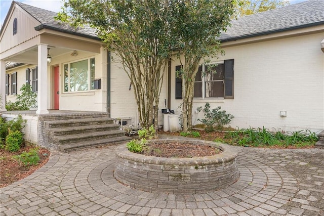 view of exterior entry with covered porch