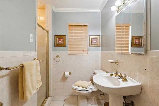 full bath with ornamental molding, a shower stall, tile walls, toilet, and tile patterned floors