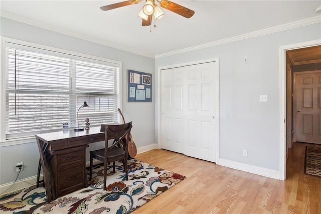 office space featuring light wood-style flooring, baseboards, and ornamental molding