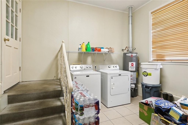 washroom featuring independent washer and dryer, ornamental molding, gas water heater, light tile patterned floors, and laundry area