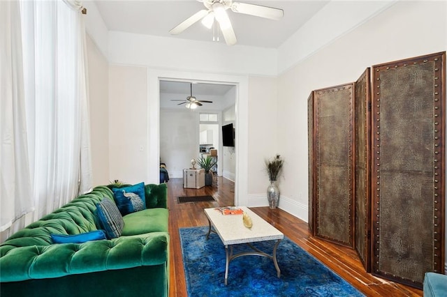 living room featuring ceiling fan and dark hardwood / wood-style flooring