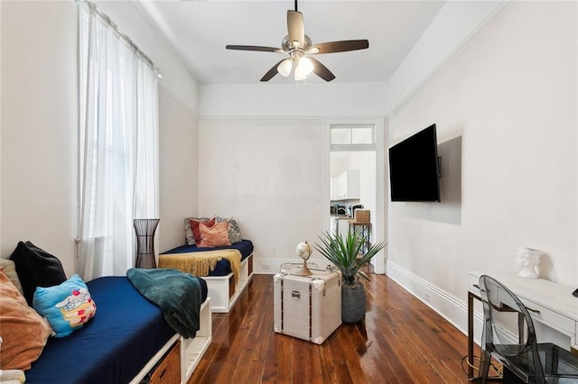 bedroom with multiple windows, ceiling fan, and dark hardwood / wood-style flooring