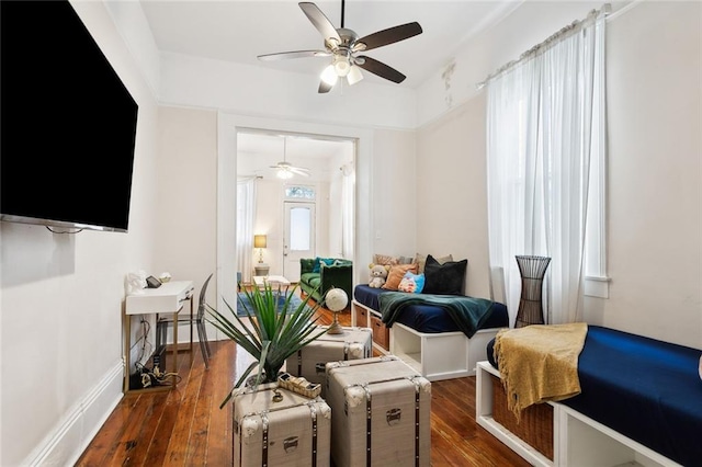 sitting room with dark hardwood / wood-style flooring, plenty of natural light, and ceiling fan