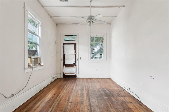 unfurnished room with dark hardwood / wood-style floors, ceiling fan, and a baseboard radiator