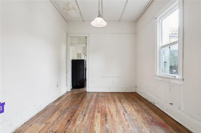 unfurnished room featuring dark hardwood / wood-style flooring