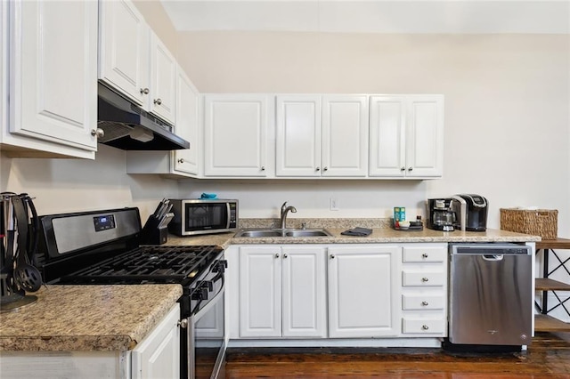 kitchen with white cabinets and appliances with stainless steel finishes