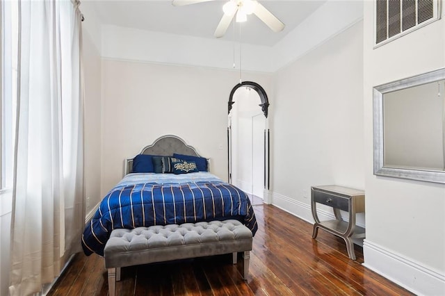 bedroom with dark hardwood / wood-style floors and ceiling fan