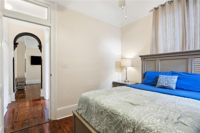 bedroom with ceiling fan and dark hardwood / wood-style flooring