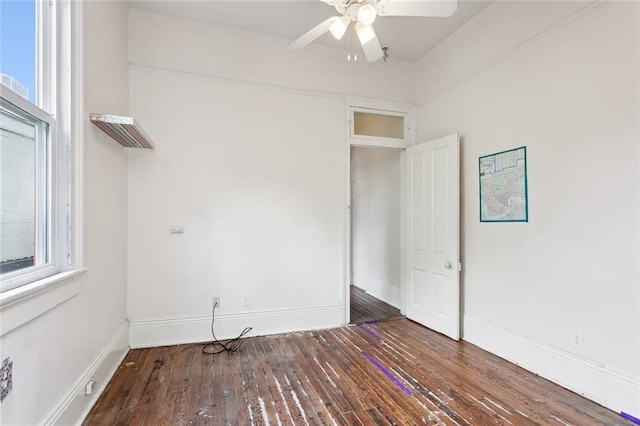 spare room featuring ceiling fan and dark wood-type flooring