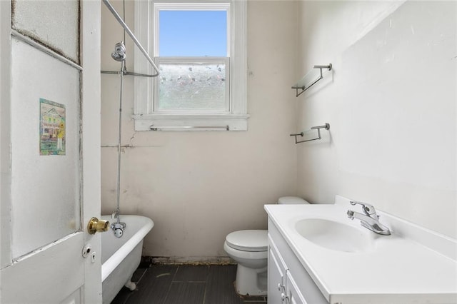 bathroom featuring a bathtub, toilet, and vanity