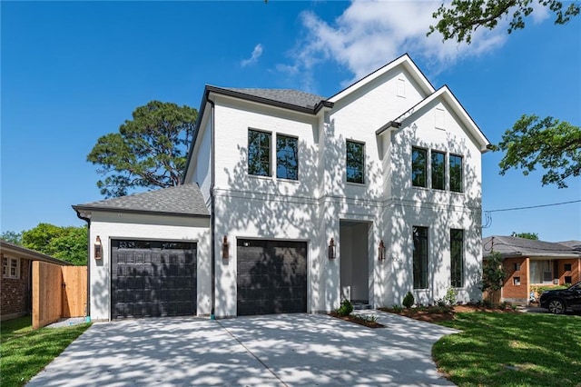 view of front of home featuring a garage and a front lawn