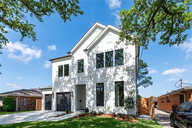 view of front of property with a front yard and a garage