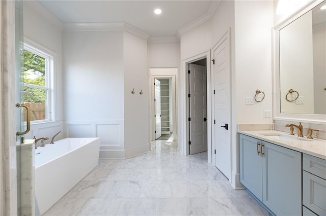 bathroom featuring crown molding, vanity, and a bath