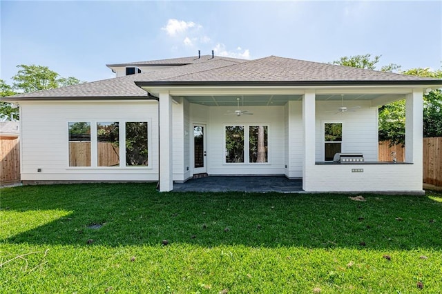 back of house featuring ceiling fan, a patio area, and a lawn