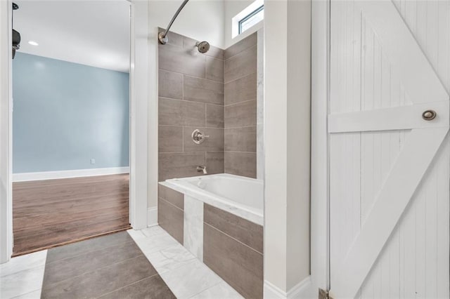 bathroom with tile patterned flooring and tiled shower / bath combo