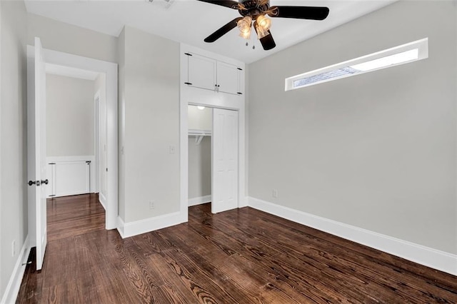 unfurnished bedroom with ceiling fan, dark wood-type flooring, and a closet