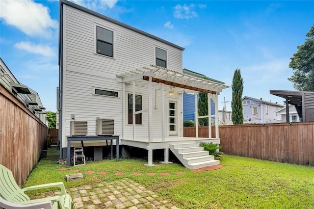 rear view of property with a pergola, central air condition unit, and a lawn