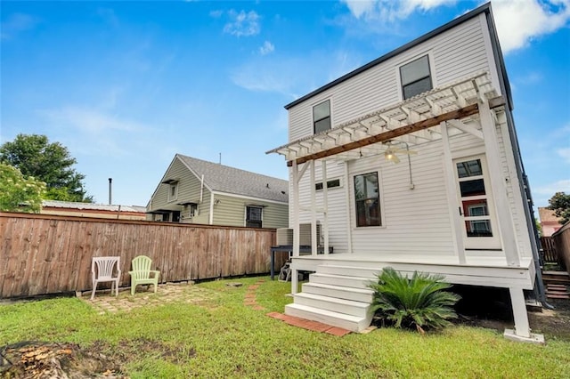 rear view of property with a yard, a deck, and a pergola