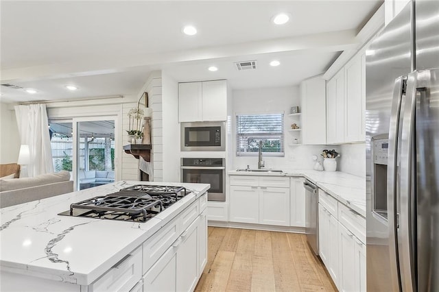 kitchen with white cabinetry, sink, and appliances with stainless steel finishes