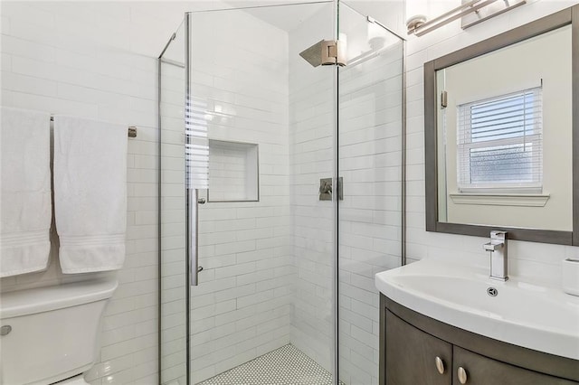 bathroom with vanity, toilet, and a shower with shower door