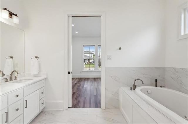 bathroom with a bathing tub and vanity