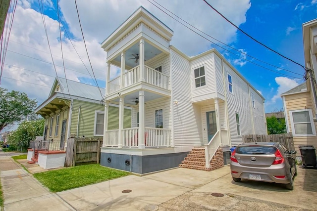 view of front of home with ceiling fan, a balcony, and a porch