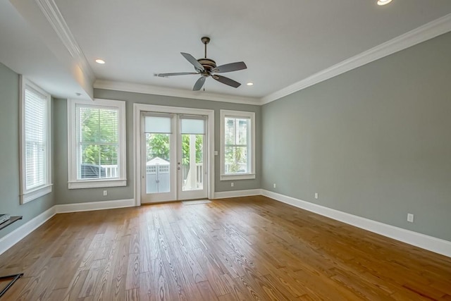 spare room with crown molding, ceiling fan, light wood-type flooring, and french doors