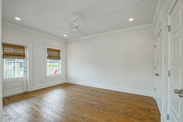 empty room with wood-type flooring, ornamental molding, and ceiling fan