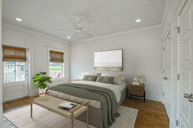 bedroom with ceiling fan, ornamental molding, and wood-type flooring