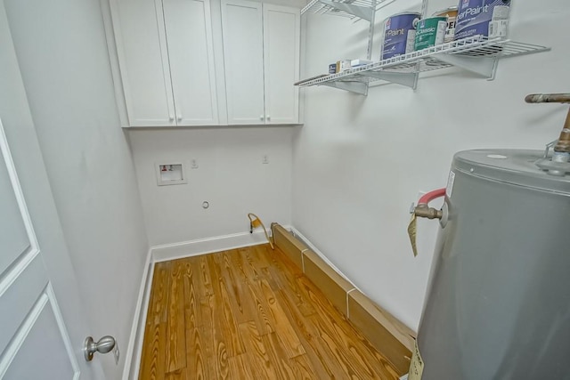 laundry area featuring cabinets, hookup for a washing machine, light hardwood / wood-style flooring, and gas water heater