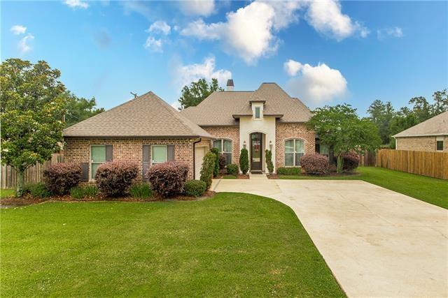 french country inspired facade with a front lawn