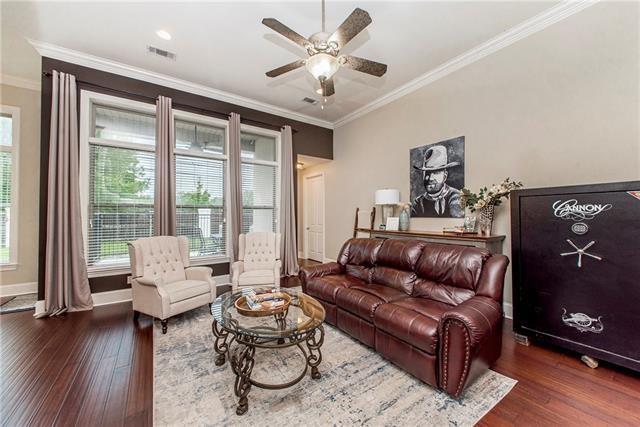 living room with ceiling fan, ornamental molding, and dark hardwood / wood-style floors