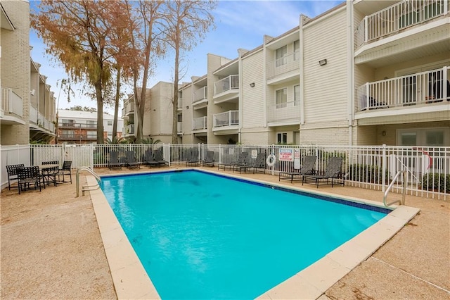 pool featuring a patio and fence