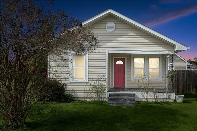 bungalow-style house with a lawn